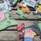 A young child's hands doing a jigsaw